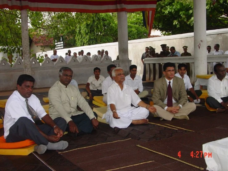 men sitting in a circle doing exercises