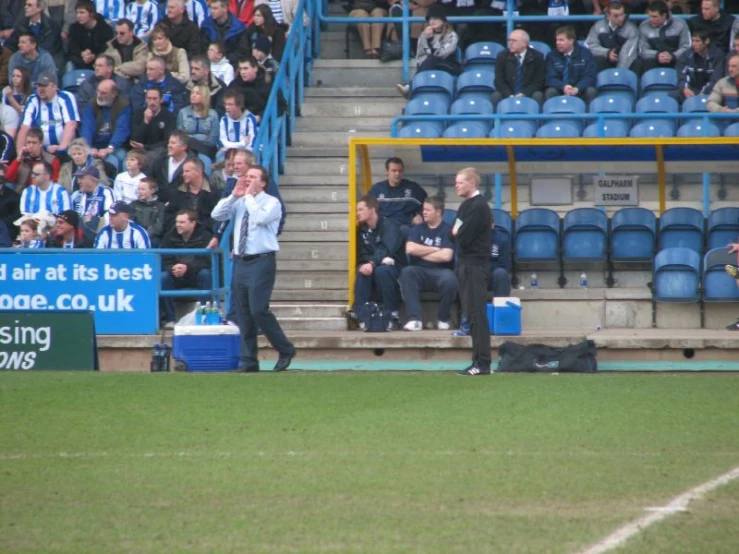 a soccer player in the stands with the rest of the team and coaches