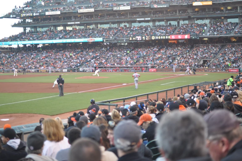 many people in the stands watching the baseball game