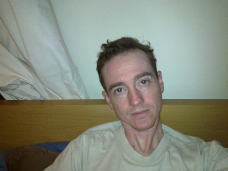 an image of a man sitting in bed