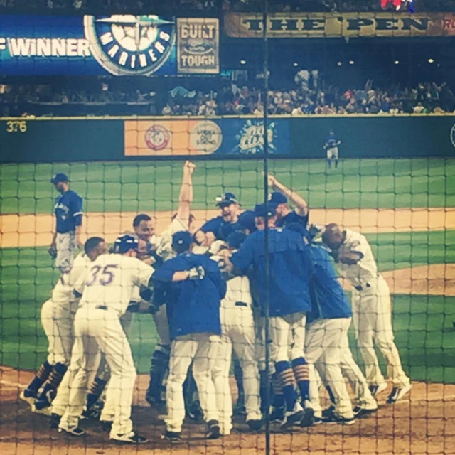 the baseball team is congratulating each other at the plate