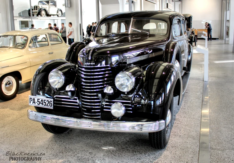 a classic car and two others in a room