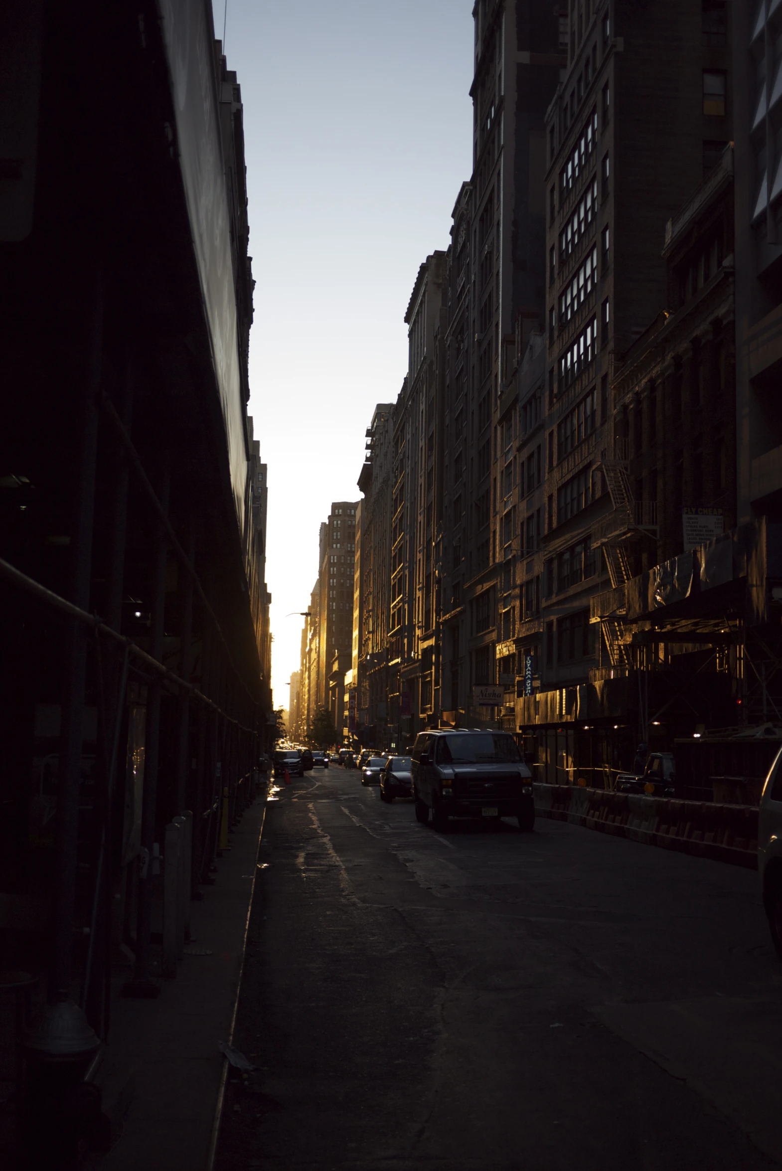 cars parked along a city street in the evening