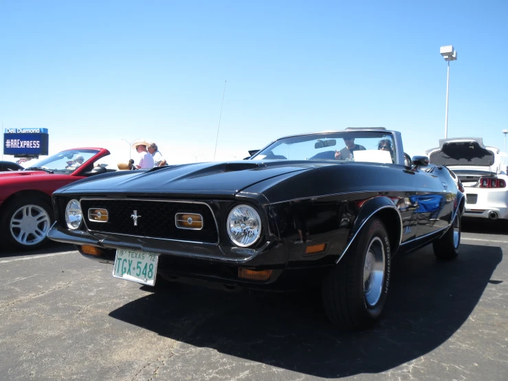 a black and red mustang parked in a parking lot