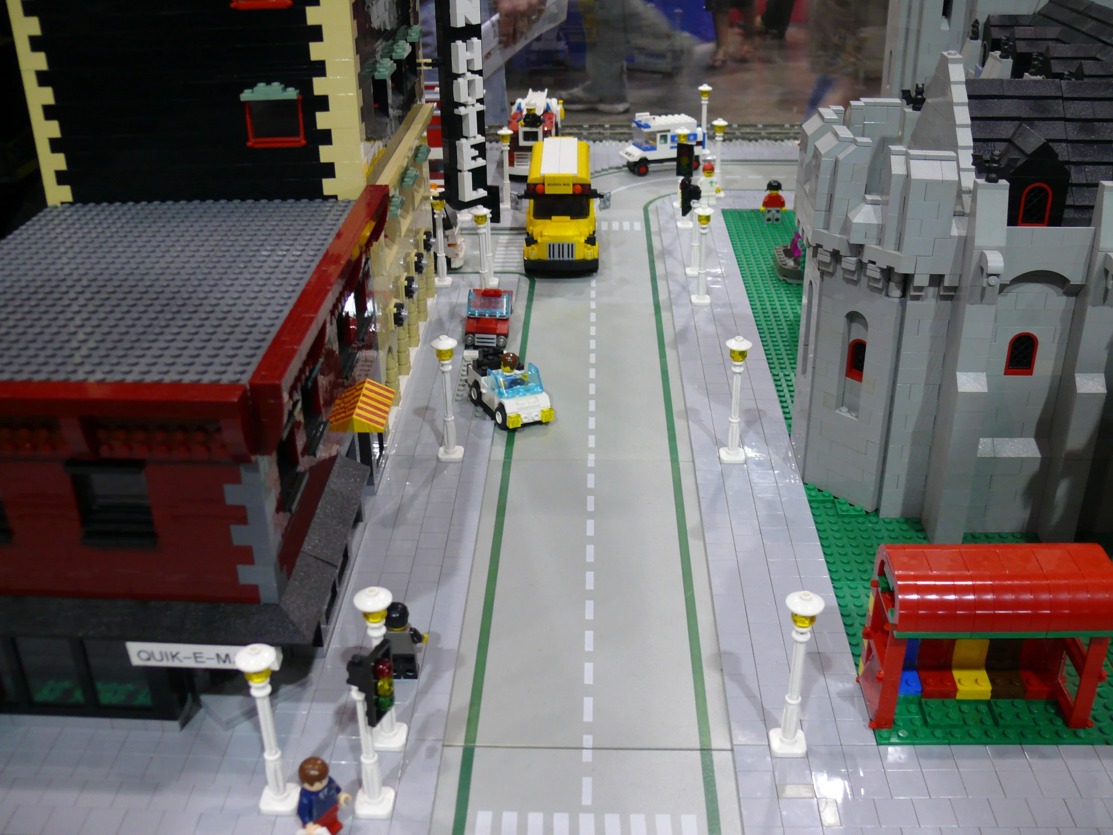 toy city with street and roadway with cars and people