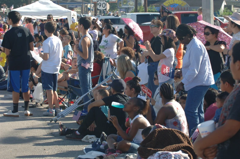 a crowd of people that are standing in the street