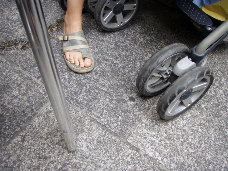 a person is standing next to a baby stroller