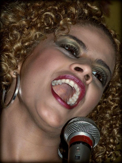 the woman is singing into a microphone