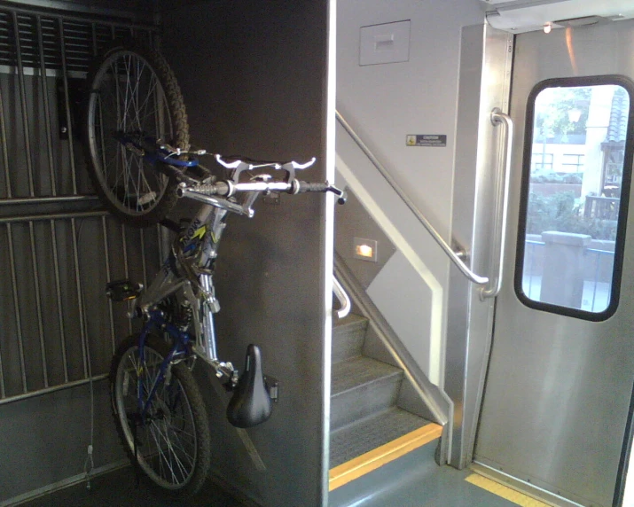 a bicycle that is attached to the side of a door