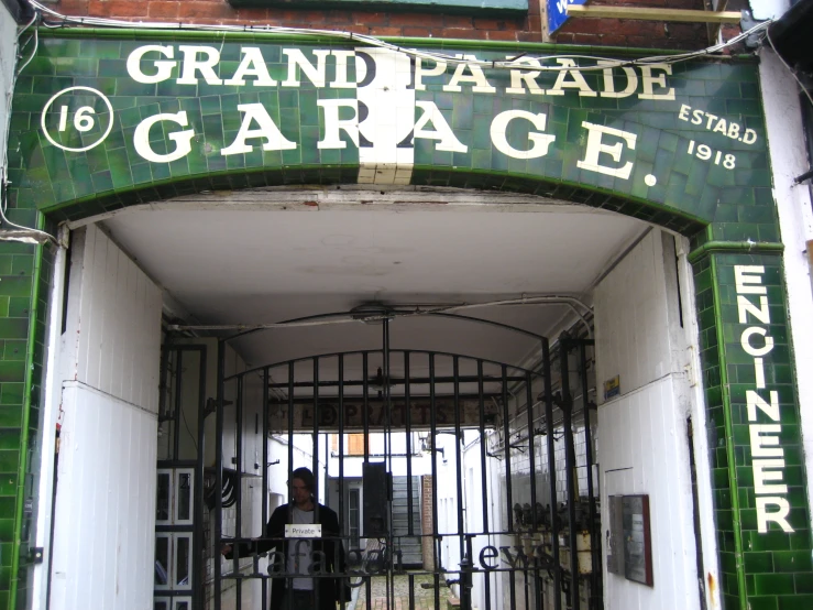 a gated entrance to a building that reads grand paradise garage