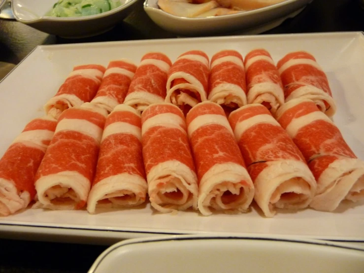 many appetizers are arranged on a white tray