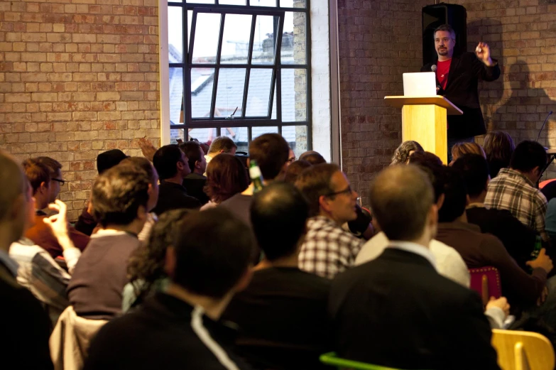 a man is standing on a podium speaking