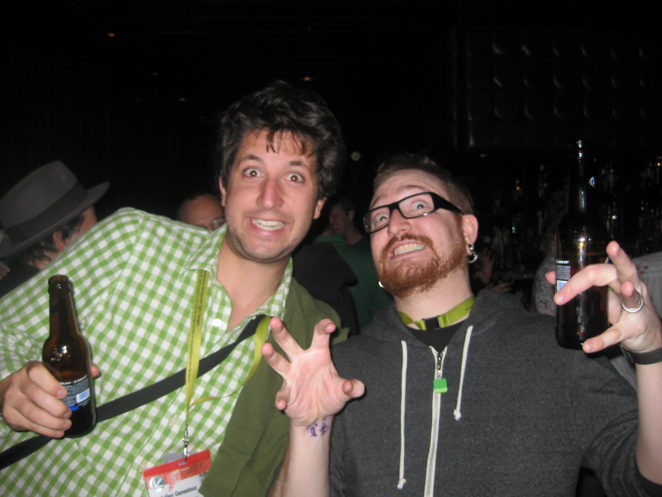 a couple of men standing next to each other at a bar