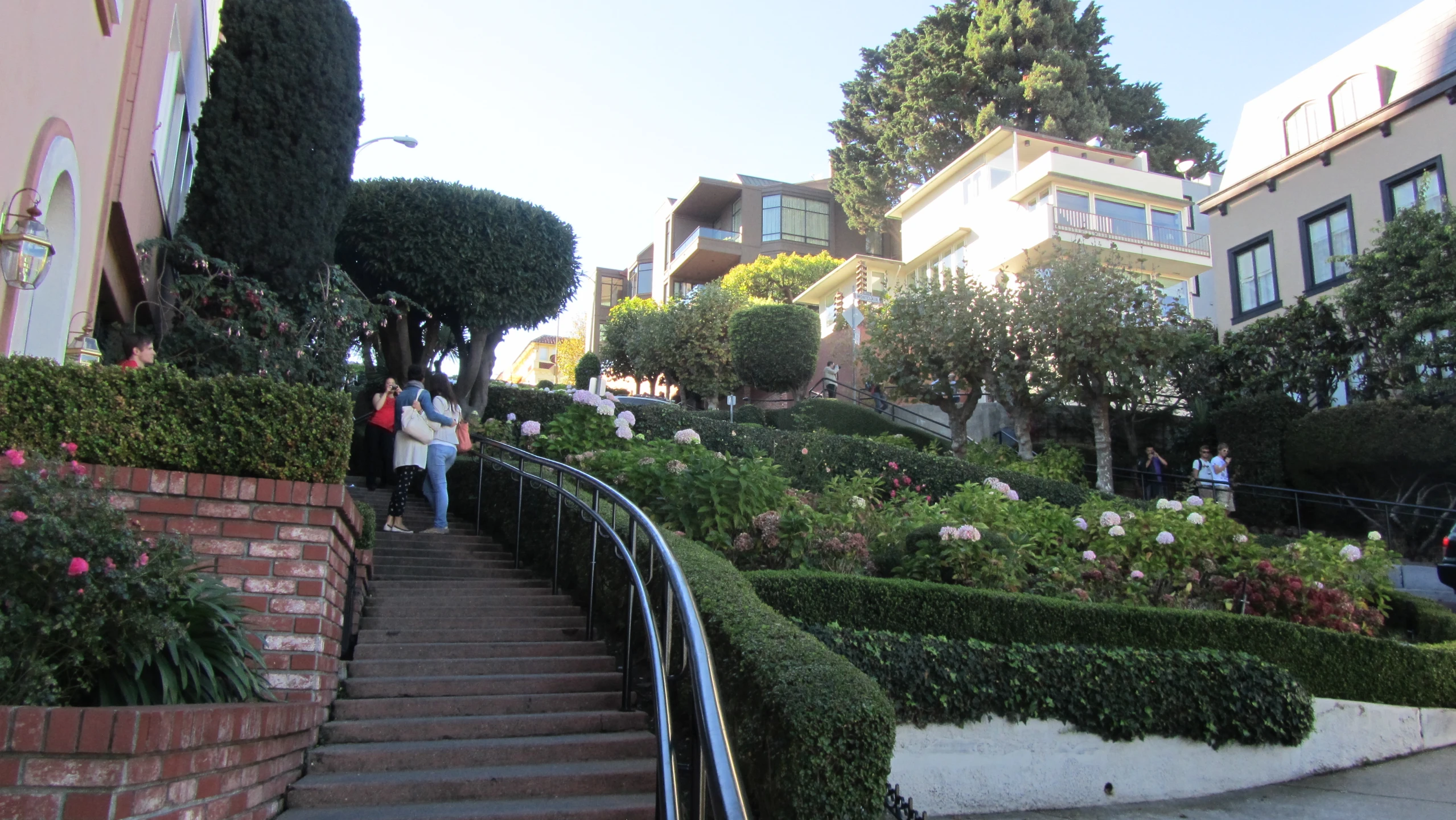 a view up a stairs towards residential houses