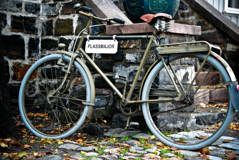 a rusted out bike parked against a wall