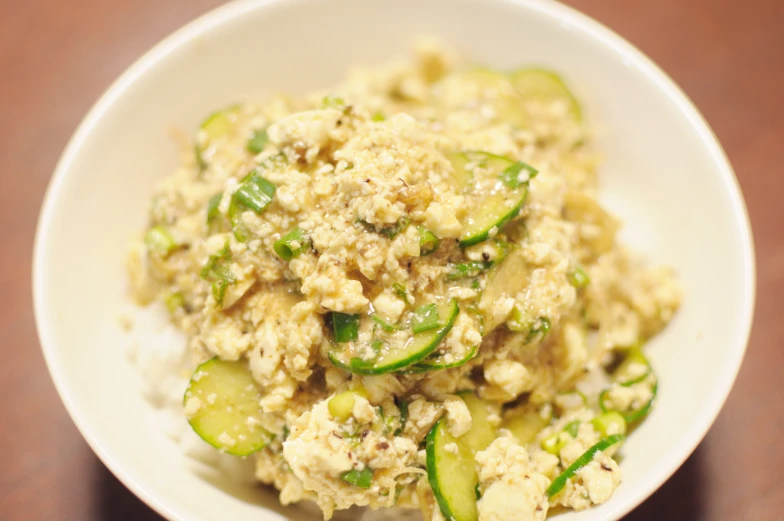 this is a plate full of rice with cucumbers