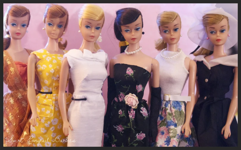 a line of barbie dolls of different shapes and sizes