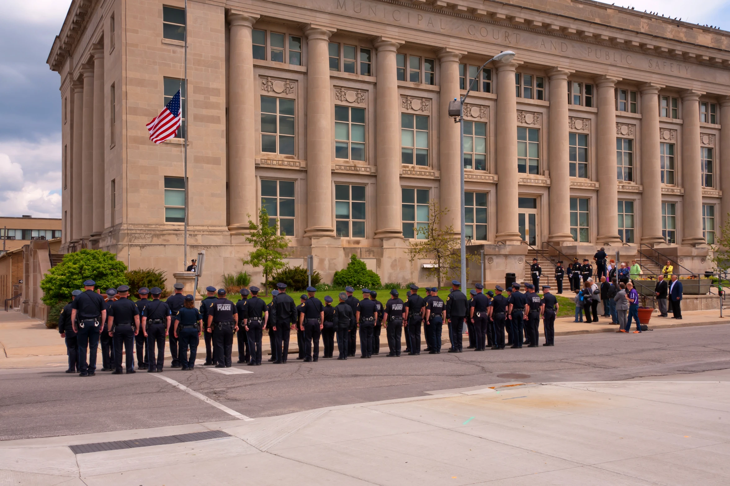 a large group of police officers standing outside an old building