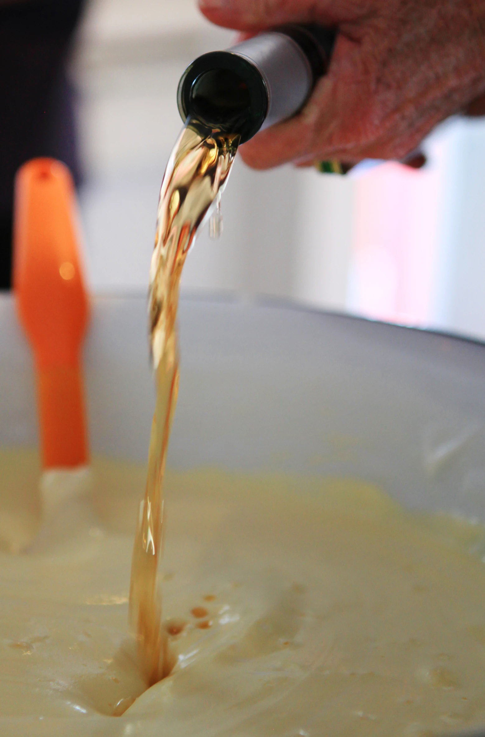 a person pours cream over a bowl