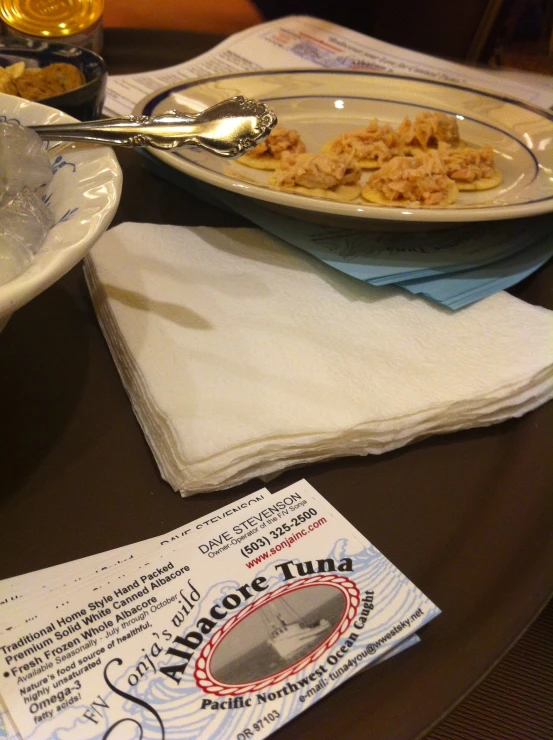 a white plate topped with pasta next to bowls of noodles