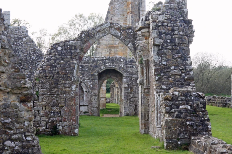 an old brick building with a stone archway in the center