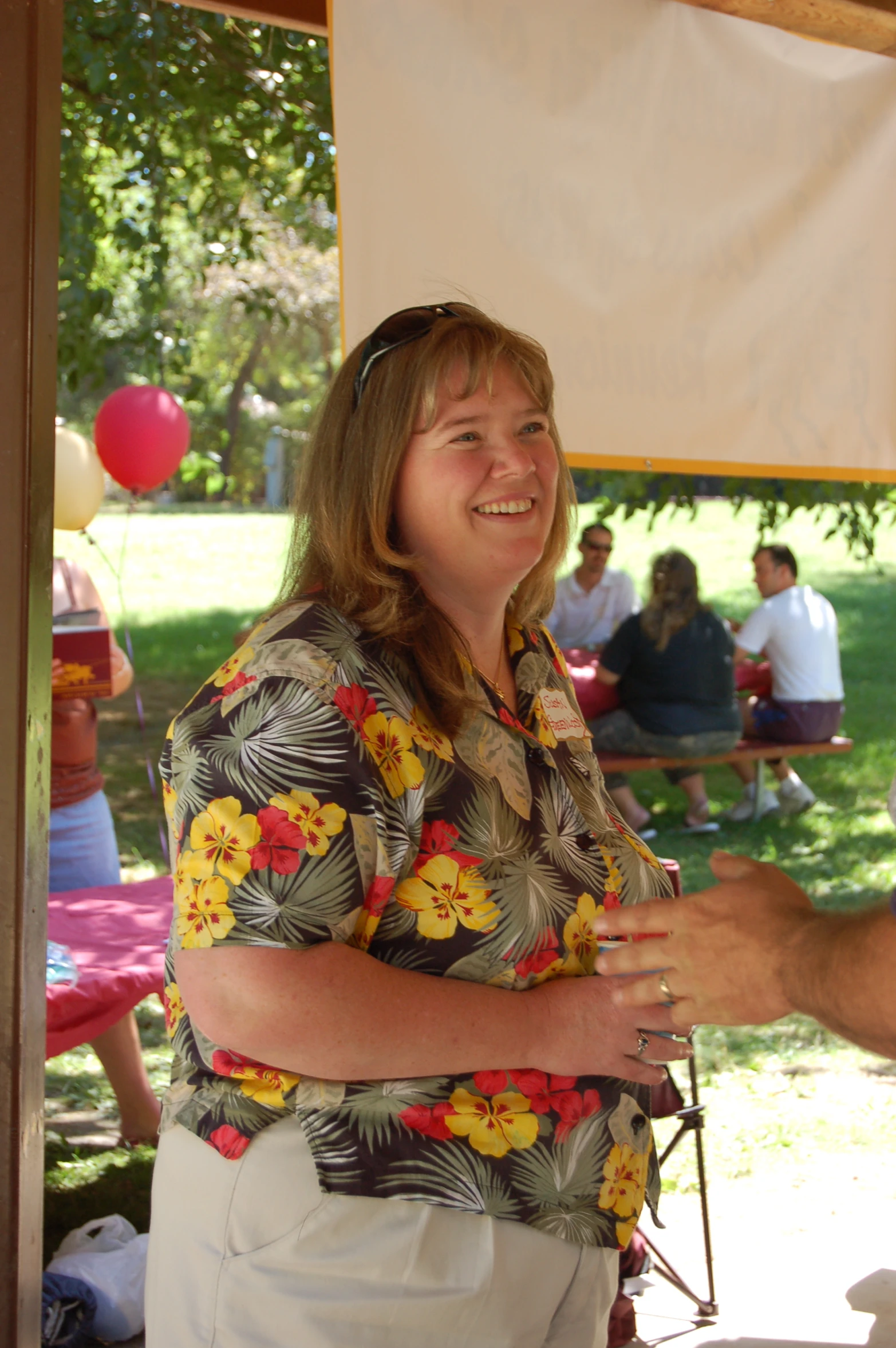 a man shaking a woman's hand on a picnic table