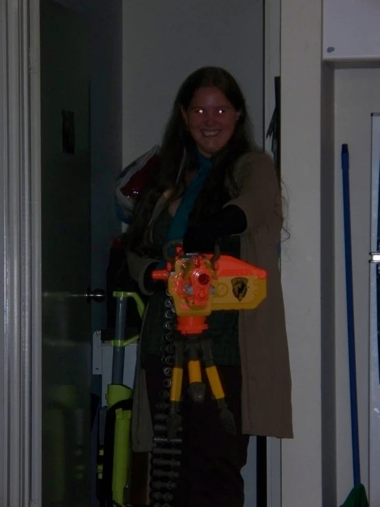 a lady holding up a nerf gun for the camera