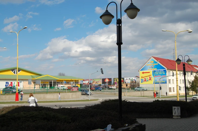 an empty street corner with people walking