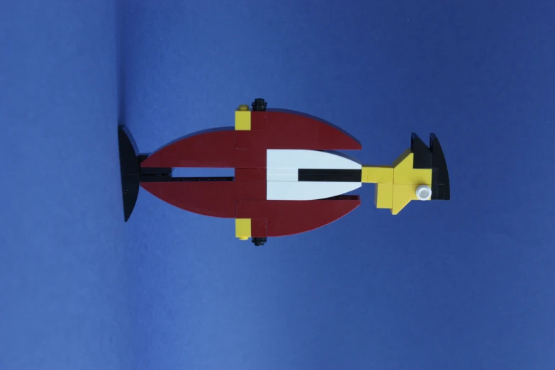 a lego man holding on to the neck of a red and white outfit