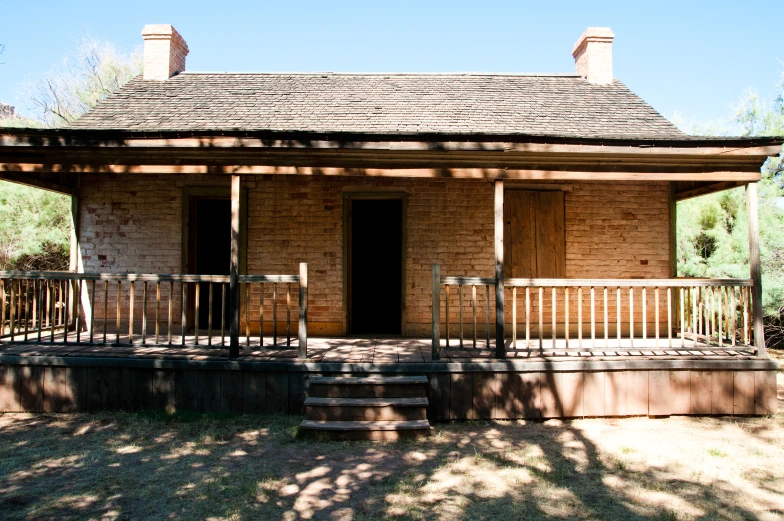 a small brick building with steps and railings