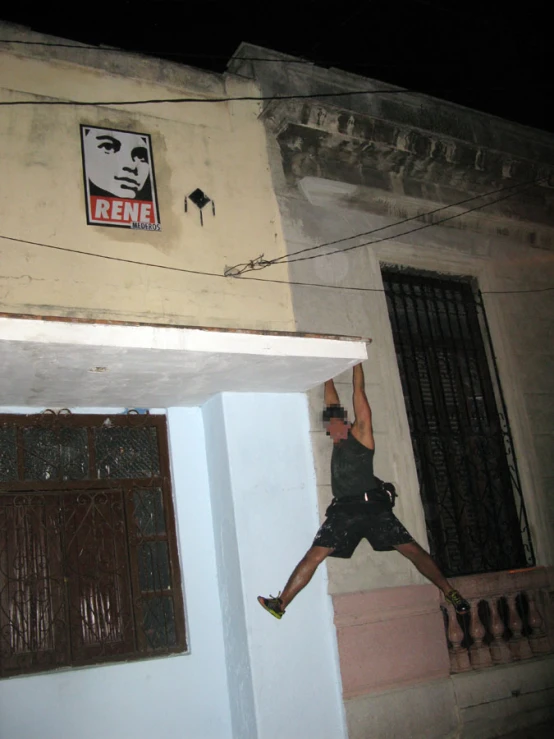 a man is holding onto a kite attached to a wall