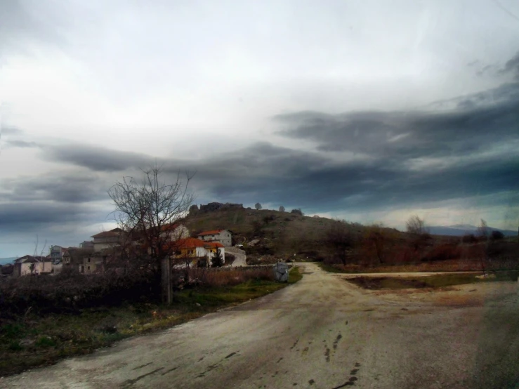 an old, run down, deserted road in the middle of a rural area