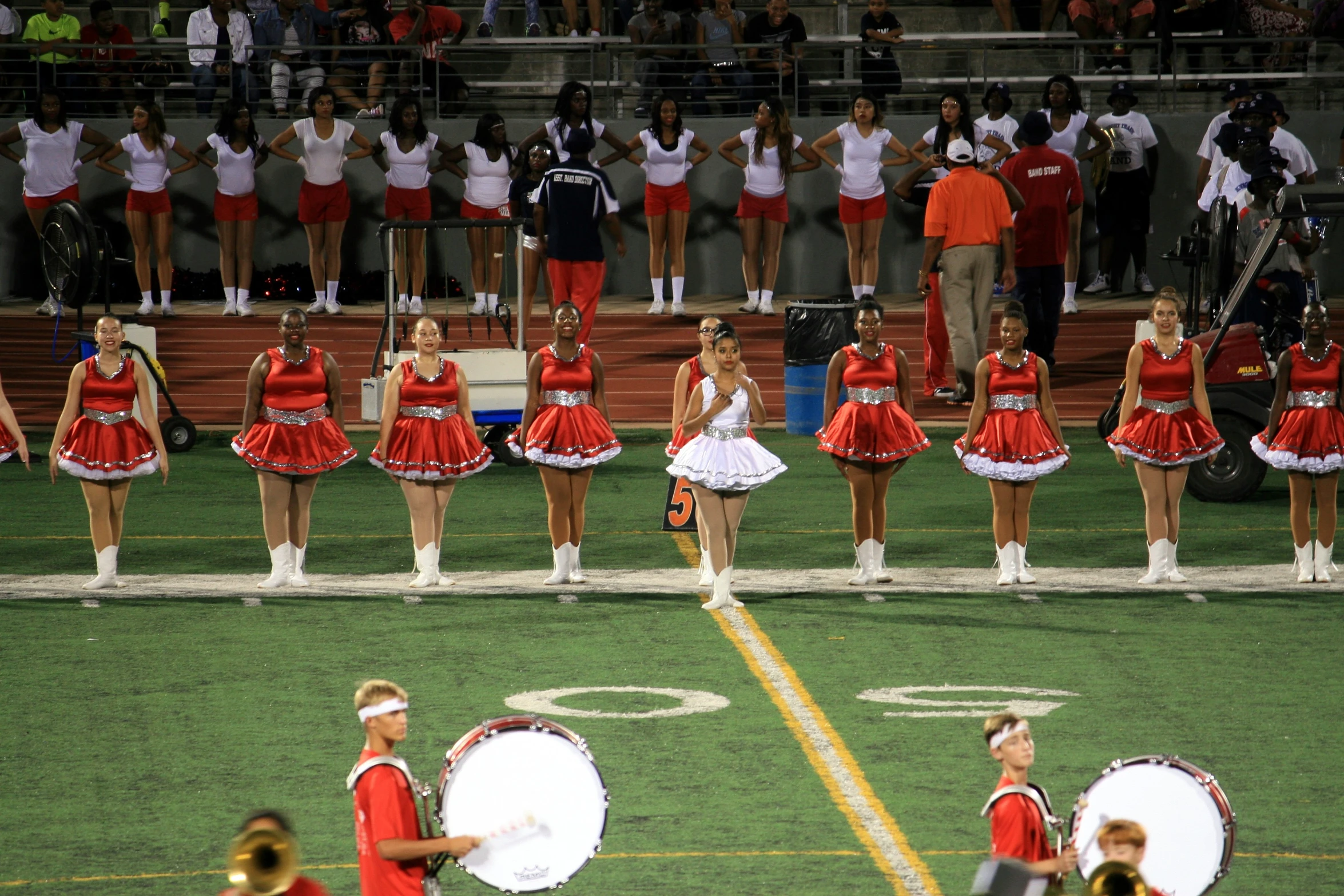 cheerleaders perform during the competition in red dresses