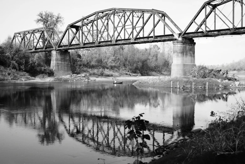 a black and white po of a bridge and water