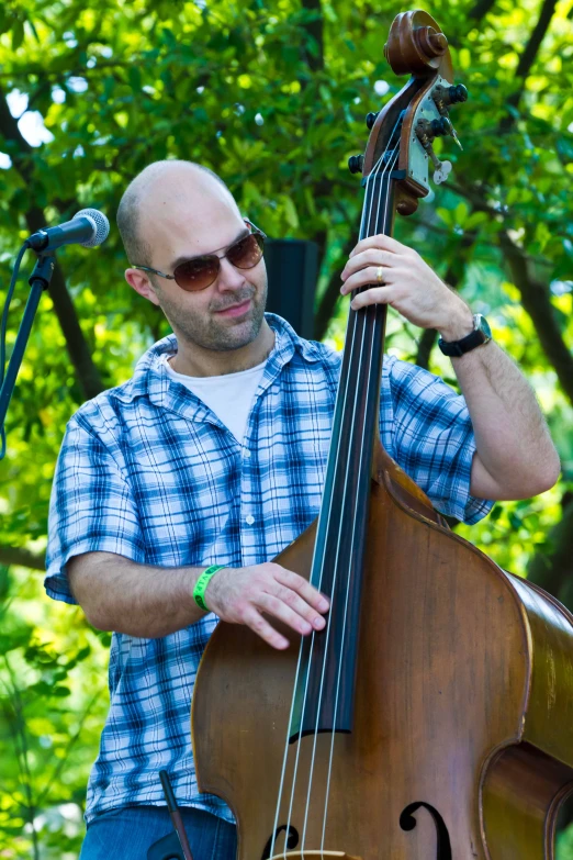 a man playing an instrument while holding it