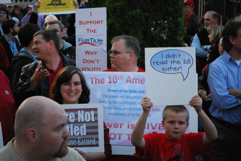 the people holding signs have written words from the same person