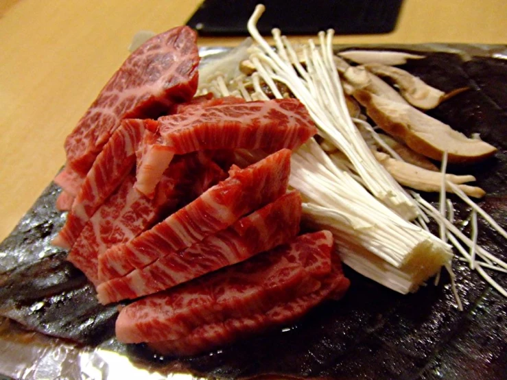 strips of meat that are sitting on tin foil