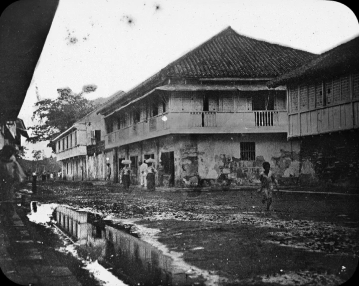 people stand on the porch of an old house