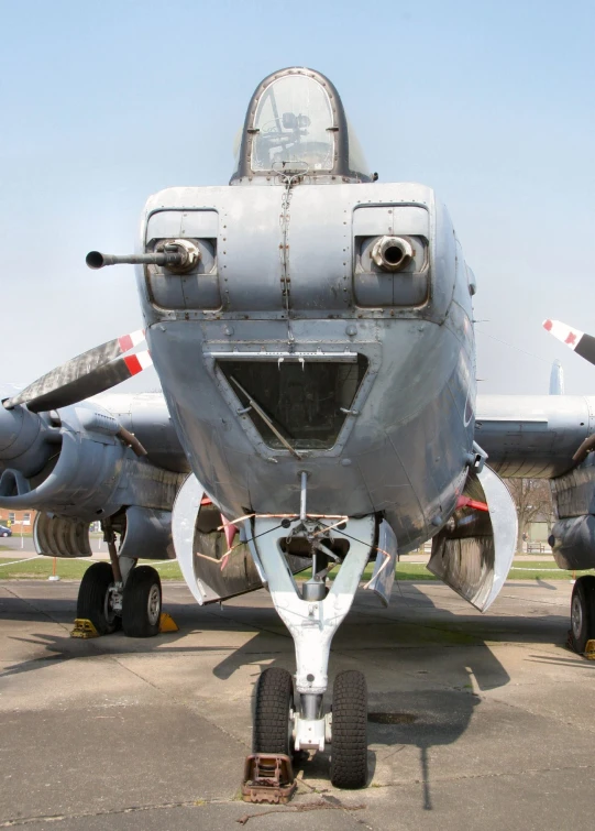 a silver airplane parked on the tarmac