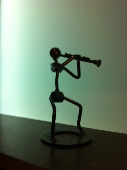 the figurine is holding his violin as if playing it
