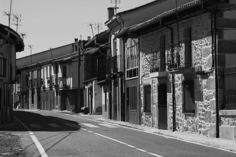 a man walking on a sidewalk next to old buildings