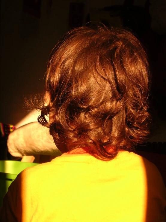 a close up of a child wearing a yellow shirt