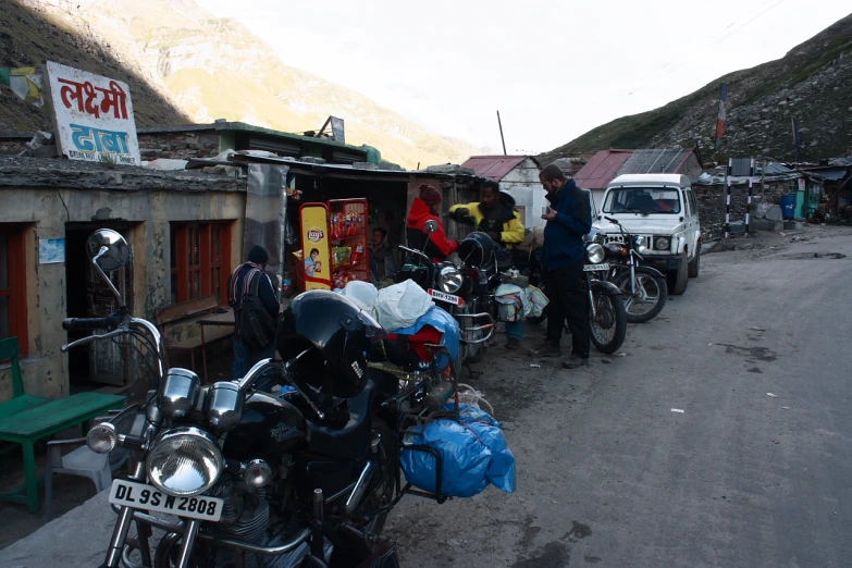 a row of parked motorcycles parked on the side of a road