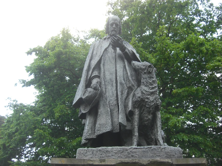 a statue of a man holding the hand of a dog