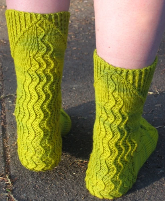 a person's legs and socks in bright green