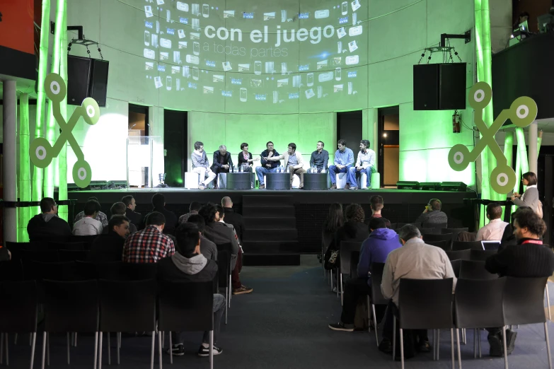 a crowd sits on the stage during a concert