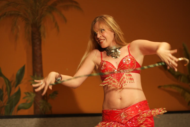 a woman is wearing an oriental outfit and doing a belly dance