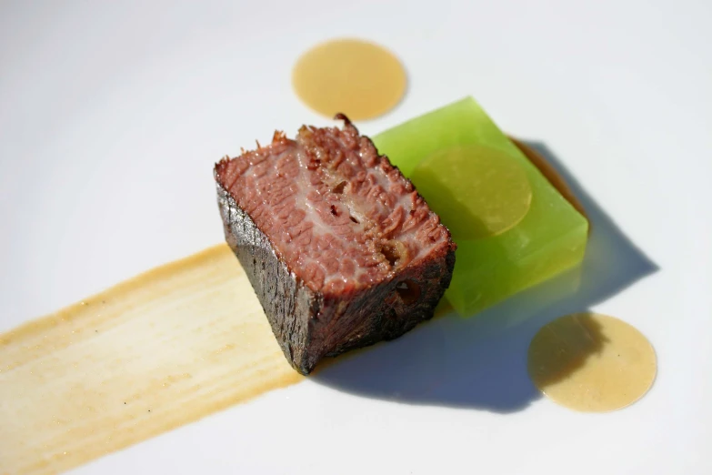 a piece of meat sitting on top of a wooden  board