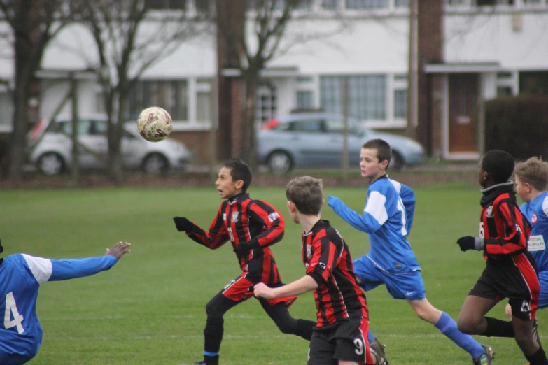 a soccer team with players and a ball in the air