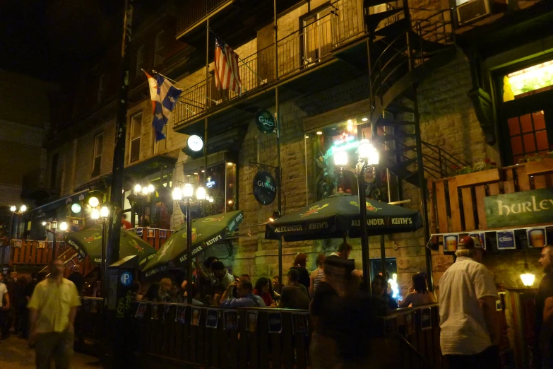 people on the street outside of a restaurant at night